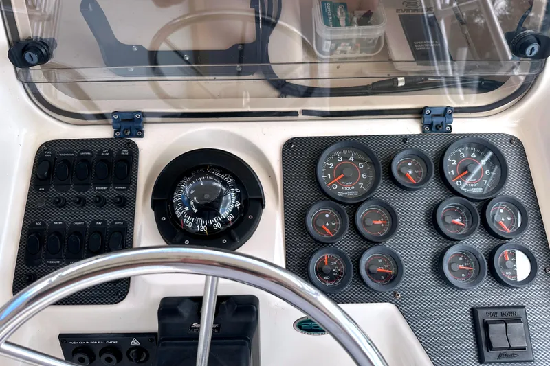 Slide: The Image of Dashboard of a 2000 Grady-White Express 265 boat with gauges and compass. - 17