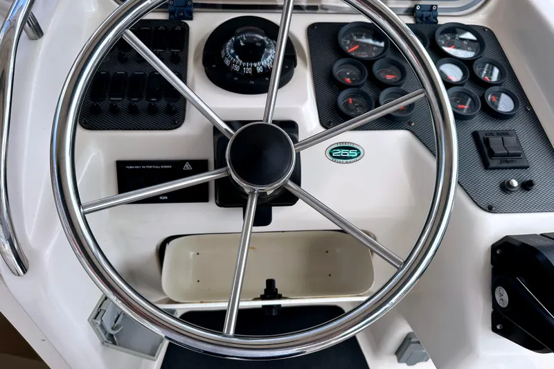 Slide: The Image of Steering wheel and dashboard of 2000 Grady-White Express 265 boat. - 18