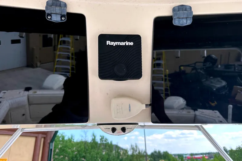 Slide: The Image of Raymarine equipment on 2000 Grady-White Express 265 boat dashboard. - 19