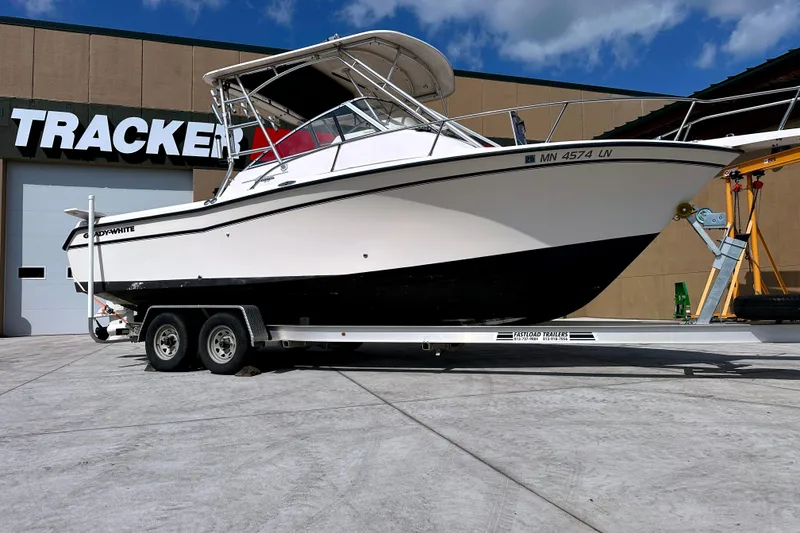 Slide: The Image of 2000 Grady-White Express 265 boat on trailer, parked outside Tracker building. - 2