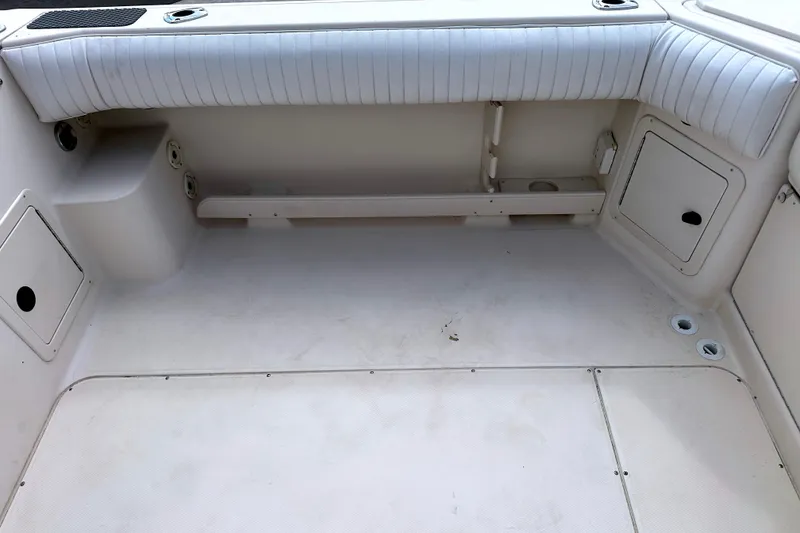 Slide: The Image of 2000 Grady-White Express 265 boat interior with storage compartments and seating. - 20