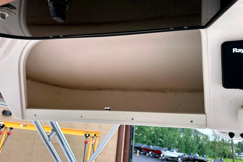 Slide: The Image of 2000 Grady-White Express 265 boat interior storage compartment with Raymarine equipment. - 24