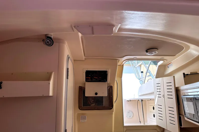 Slide: The Image of Interior view of 2000 Grady-White Express 265 boat cabin with storage compartments. - 27