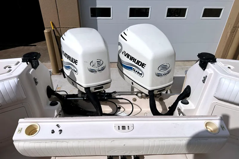 Slide: The Image of Twin Evinrude outboard engines on a 2000 Grady-White Express 265 boat. - 30