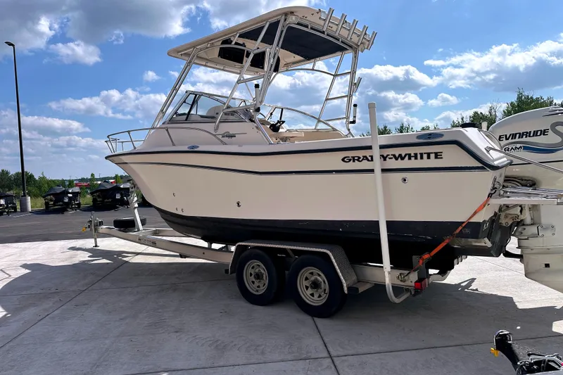 Slide: The Image of 2000 Grady-White Express 265 boat on trailer under blue sky. - 4