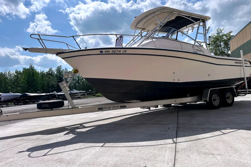 Slide: The Image of 2000 Grady-White Express 265 boat on trailer under blue sky. - 5