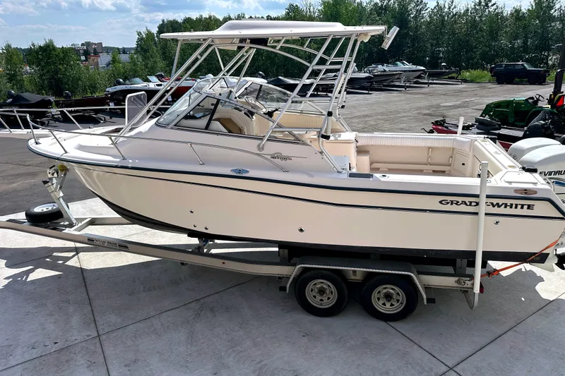 Slide: The Image of 2000 Grady-White Express 265 boat on trailer, parked outdoors, side view. - 7