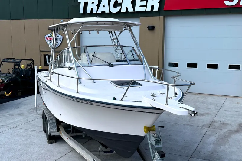 Slide: The Image of 2000 Grady-White Express 265 boat on trailer, parked outside a dealership. - 8