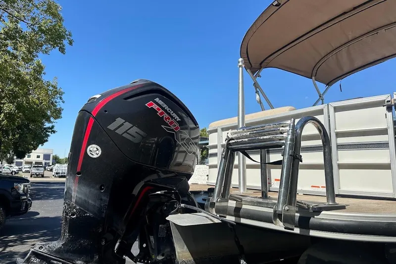 Slide: The Image of 2017 Ranger Reata 220C with Mercury Pro XS outboard motor, parked under clear blue sky. - 10