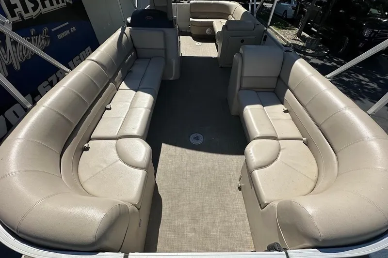 Slide: The Image of 2017 Ranger Reata 220C pontoon boat with spacious beige seating and carpeted deck. - 11