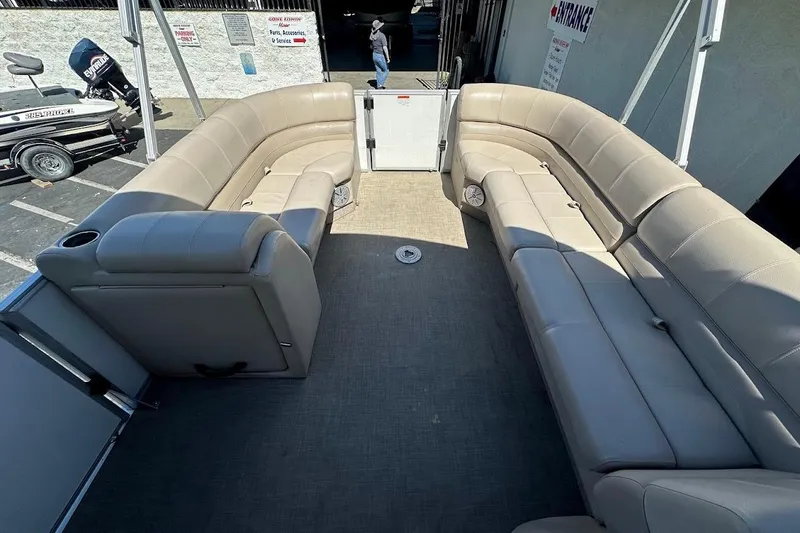 Slide: The Image of 2017 Ranger Reata 220C pontoon boat with spacious beige seating. - 14