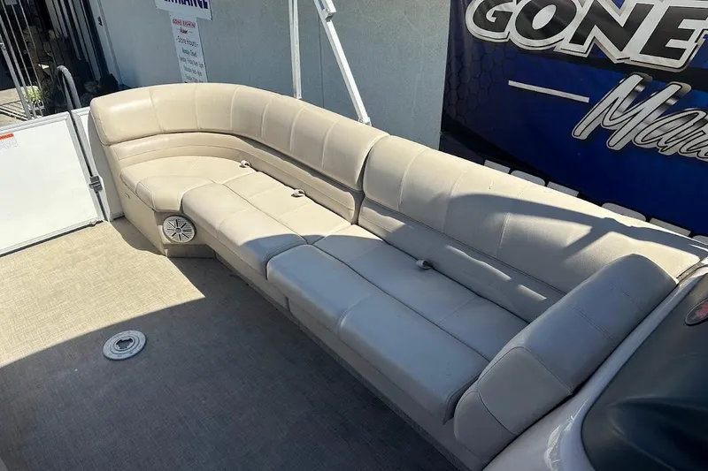 Slide: The Image of 2017 Ranger Reata 220C boat interior with beige seating and carpeted floor. - 15