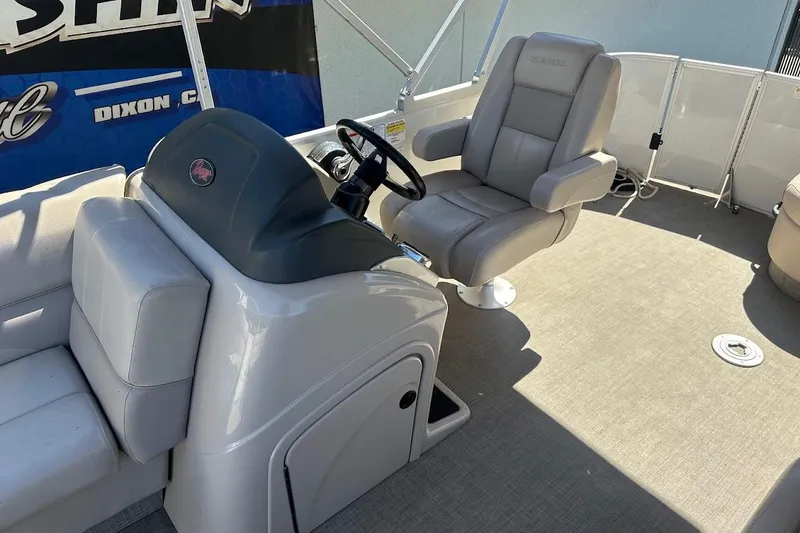 Slide: The Image of 2017 Ranger Reata 220C boat interior with steering console and seating. - 16