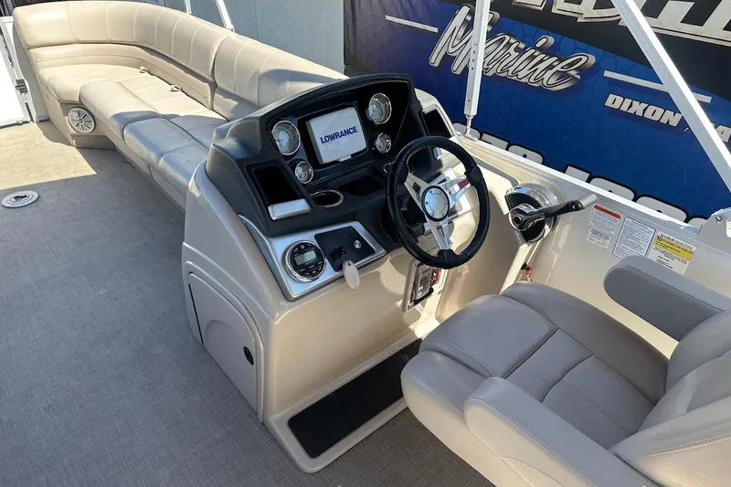 Slide: The Image of 2017 Ranger Reata 220C boat interior with steering console and seating. - 17