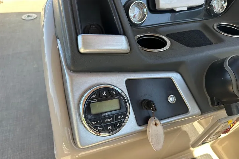 Slide: The Image of Control panel of a 2017 Ranger Reata 220C boat with key and audio system. - 19