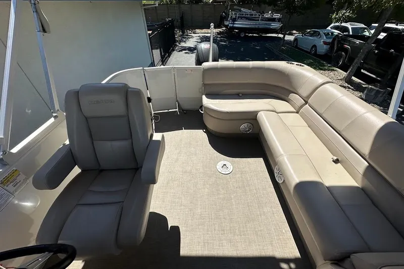 Slide: The Image of 2017 Ranger Reata 220C boat interior with beige seating and spacious layout. - 21