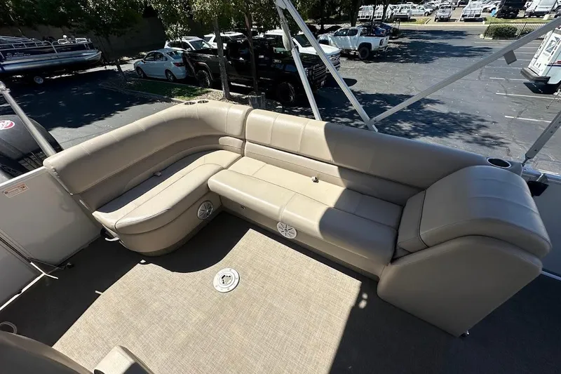 Slide: The Image of 2017 Ranger Reata 220C boat interior with beige seating and carpeted floor. - 22