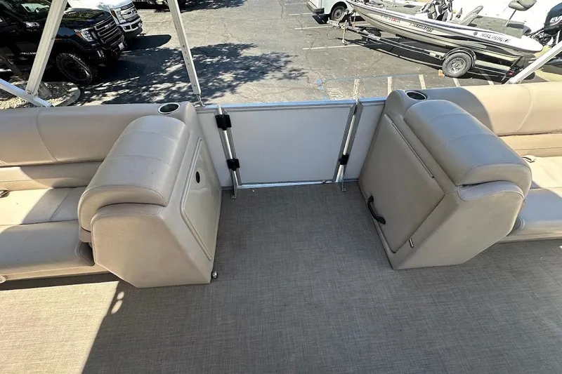 Slide: The Image of 2017 Ranger Reata 220C boat interior with beige seating and cup holders. - 25