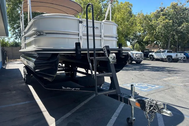 Slide: The Image of 2017 Ranger Reata 220C pontoon boat on trailer in parking lot. - 3