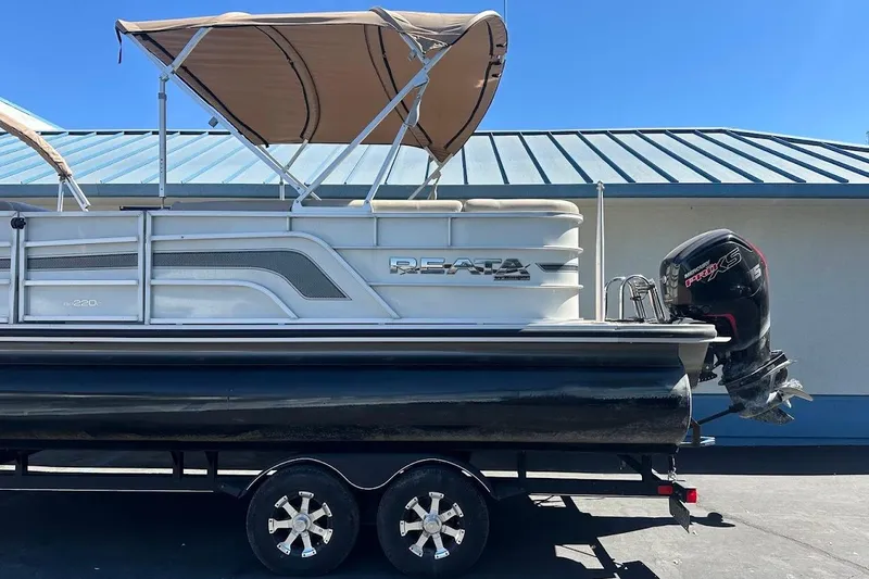 Slide: The Image of 2017 Ranger Reata 220C pontoon boat with canopy and outboard motor. - 6