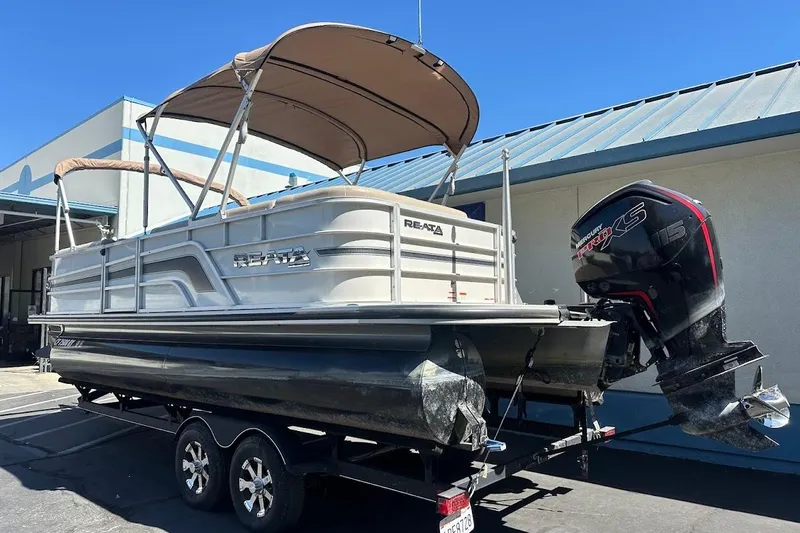 Slide: The Image of 2017 Ranger Reata 220C pontoon boat with Mercury engine on trailer. - 7
