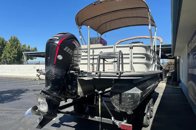 Slide: The Image of 2017 Ranger Reata 220C pontoon boat with outboard motor on trailer. - 9