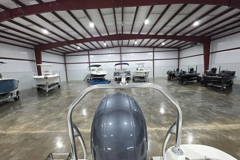 Slide: The Image of 2017 NauticStar 2302 Legacy in spacious indoor boat storage facility. - 10