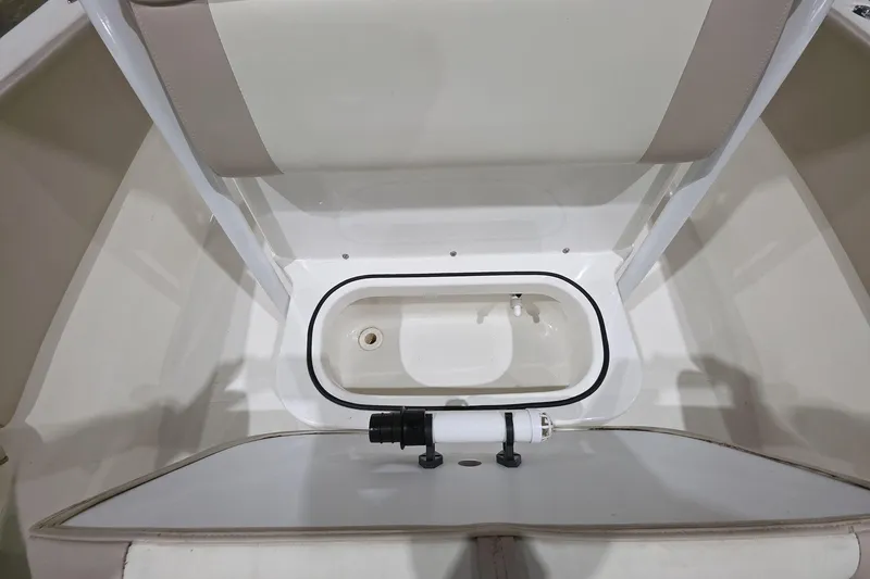 Slide: The Image of 2017 NauticStar 2302 Legacy boat interior with storage compartment and seating. - 12