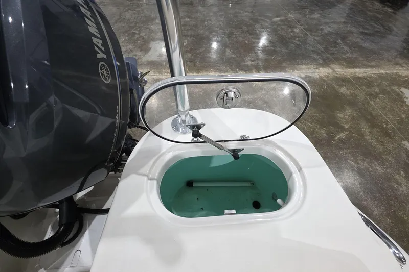 Slide: The Image of 2017 NauticStar 2302 Legacy boat with Yamaha engine and open livewell. - 13
