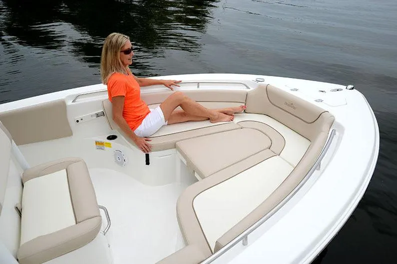 Slide: The Image of Manufacturer Provided Image: Woman relaxing on a 2017 NauticStar 2302 Legacy boat with beige seating. - 16