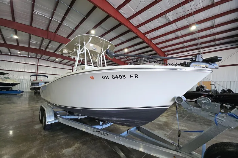 Slide: The Image of 2017 NauticStar 2302 Legacy boat on trailer in indoor storage facility. - 3