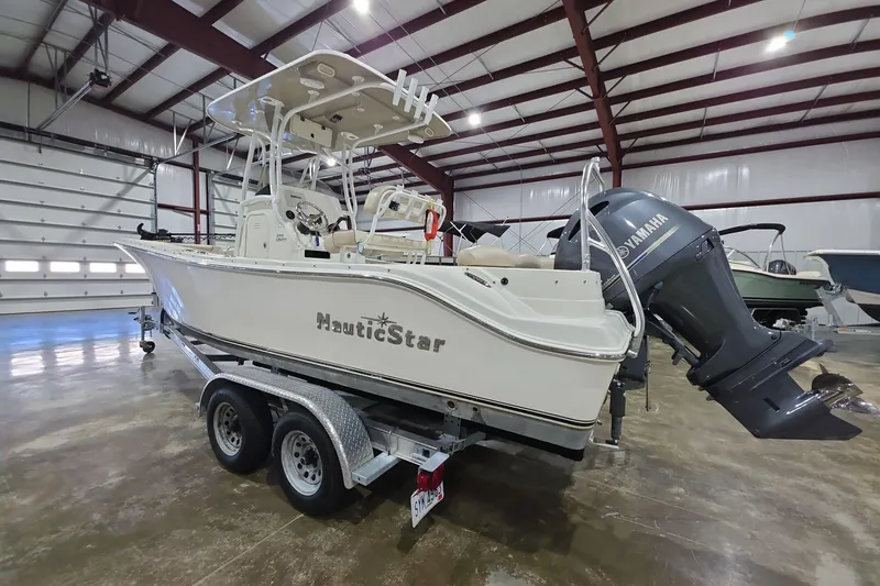 Slide: The Image of 2017 NauticStar 2302 Legacy boat on trailer in indoor storage facility. - 4