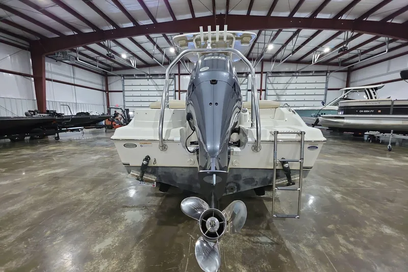 Slide: The Image of 2017 NauticStar 2302 Legacy boat in indoor storage, rear view with outboard motor. - 5