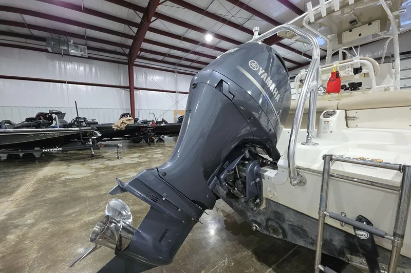 Slide: The Image of 2017 NauticStar 2302 Legacy with Yamaha outboard engine in a boat storage facility. - 6