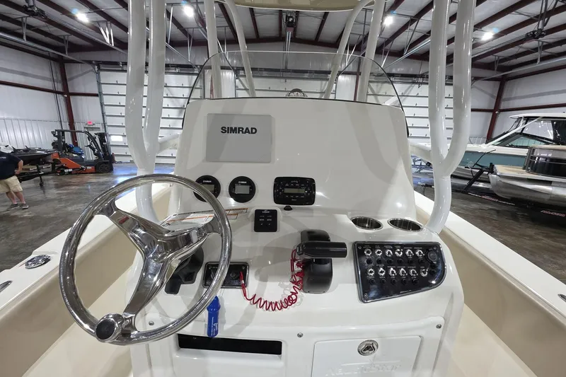 Slide: The Image of 2017 NauticStar 2302 Legacy boat console with steering wheel and Simrad electronics. - 7