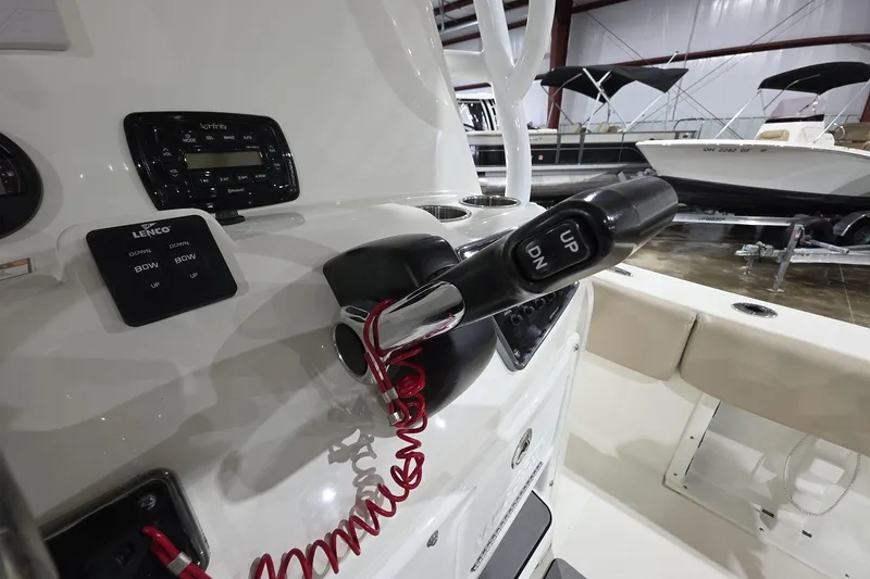 Slide: The Image of Control panel of a 2017 NauticStar 2302 Legacy boat with throttle and trim switches. - 8