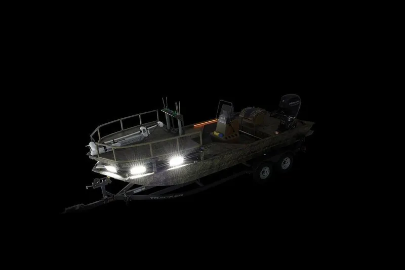 Slide: The Image of 2026 Tracker GRIZZLY® 2072 CC Sportsman boat with trailer, illuminated in darkness. - 17