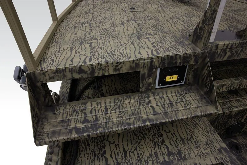 Slide: The Image of Camouflage-patterned deck of 2026 Tracker GRIZZLY® 2072 CC Sportsman boat, featuring control panel. - 23