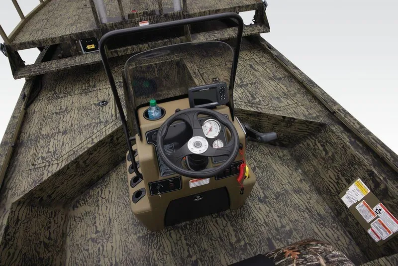 Slide: The Image of 2026 Tracker GRIZZLY® 2072 CC Sportsman boat interior with camouflage design and steering console. - 25