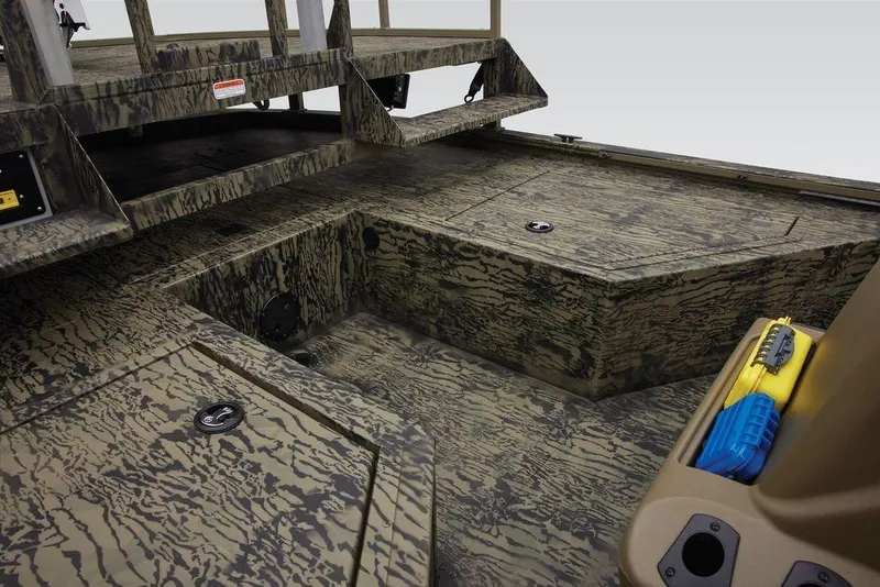Slide: The Image of 2026 Tracker GRIZZLY® 2072 CC Sportsman boat interior with camo design and storage compartments. - 27