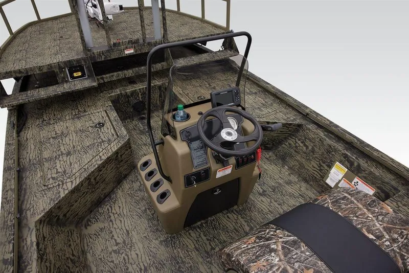Slide: The Image of 2026 Tracker GRIZZLY® 2072 CC Sportsman boat interior with camouflage design and steering console. - 28