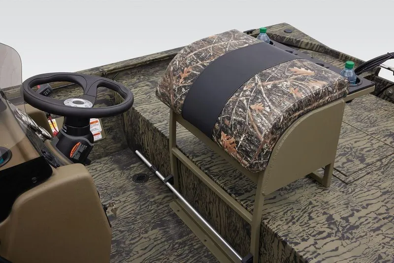 Slide: The Image of 2026 Tracker GRIZZLY® 2072 CC Sportsman boat interior with camo seat and steering wheel. - 33