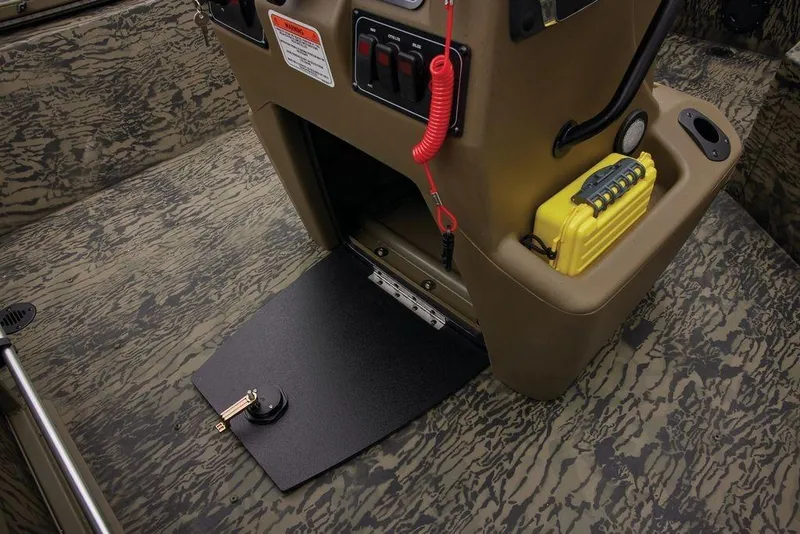 Slide: The Image of 2026 Tracker GRIZZLY® 2072 CC Sportsman boat interior with storage compartment and safety equipment. - 36