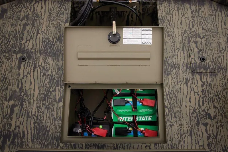 Slide: The Image of Battery compartment of 2026 Tracker GRIZZLY® 2072 CC Sportsman boat, featuring Interstate batteries. - 37