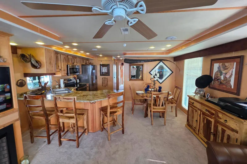 Slide: The Image of Luxurious 2015 Sailabration 64 houseboat interior with modern kitchen and dining area. - 1