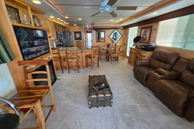Slide: The Image of Luxurious 2015 Sailabration 64 houseboat interior with modern kitchen, dining area, and cozy seating. - 11