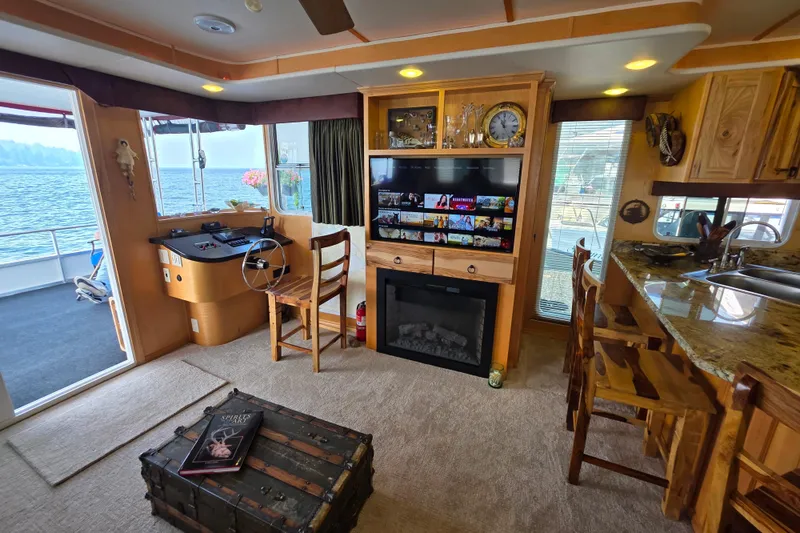 Slide: The Image of Luxurious 2015 Sailabration 64 houseboat interior with cozy living area and lake view. - 12