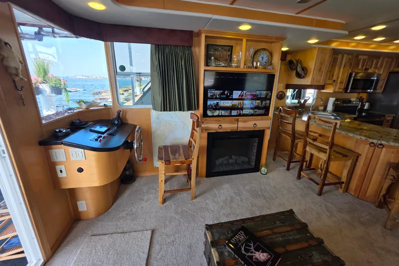 Slide: The Image of Luxurious 2015 Sailabration 64 houseboat interior with modern kitchen, cozy living area, and scenic views. - 13