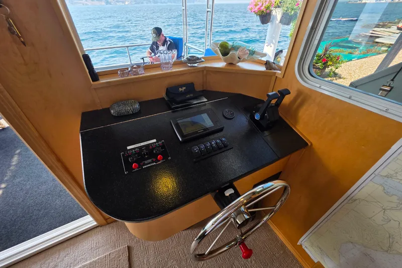 Slide: The Image of Pilothouse of 2015 Sailabration 64 boat with steering wheel, control panel, and ocean view. - 14