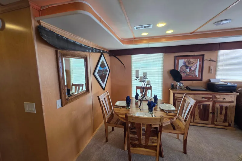 Slide: The Image of Dining area in 2015 Sailabration 64 houseboat with rustic decor and wooden furniture. - 19